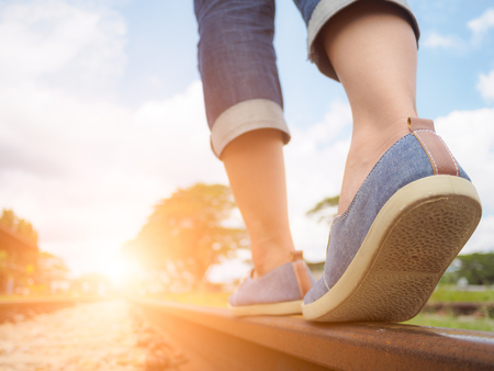 Closeup woman walking on the railway. Travel and step concept.の写真素材