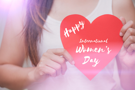 Soft focus of Woman holds handmade big red heart paper with happy women's day message. Valentines day, womens day and Love concept.の写真素材