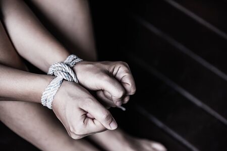 Closeup woman hands were tied with a rope. Violence, Terrified, Human Rights Day concept.の写真素材