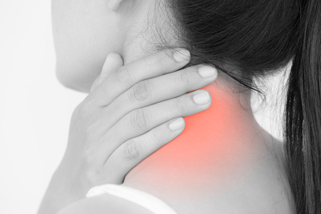 Closeup woman neck and shoulder pain and injury. Health care and medical concept.の写真素材