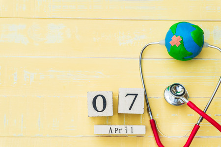 Wooden Block calendar for World health day, April 7. Healthcare and medical concept. Red heart with...
