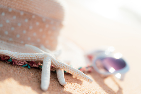 Soft focus on starfish. Beach accessories including sunglasses, starfish, flower and hat beach on Sandy beach background background for summer holiday and vacation concept.の写真素材