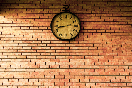Wall Clock vintage retro styles hanging on the brick wall.の写真素材
