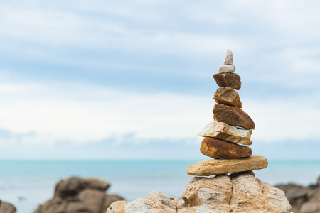 Balanced stone pyramid on  green water of ocean. life balance concept.の写真素材