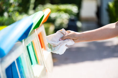 World Environment Day, June 5. Woman hand holding and putting issue paper waste into garbage trash.の写真素材