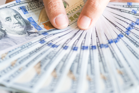 Close up woman hands holding us dollar bills.の写真素材