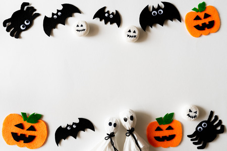 Top view of Halloween crafts, orange pumpkin, ghost and spide on white background with copy space for text. halloween concept.の写真素材