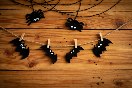 Halloween crafts, bat, spide and cobweb on wooden table background with Happy Halloween text. halloween concept.の写真素材