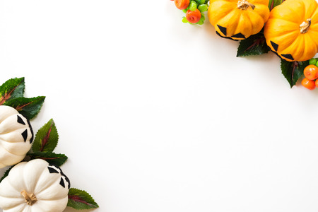 Top view of white and yellow ghost pumpkins on white background. halloween concept.の写真素材