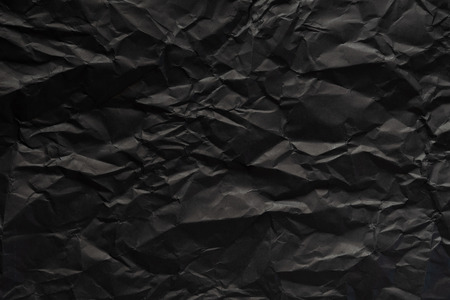 Black crumpled paper texture background.の写真素材