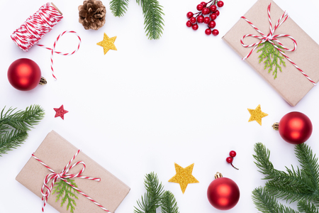 Christmas background concept. Top view of Christmas gift box red sock with spruce branches, pine cones, red berries and bell on white background.