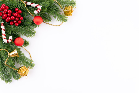 Christmas background concept. Top view of Christmas gift box red balls with spruce branches, pine cones, red berries and bell on white background.の写真素材