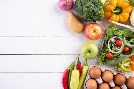 Healthy lifestyle and food concept. Top view of fresh vegetables, fruit, herbs and spices with a...