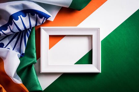 Top view of picture frame with National Flag of India on orange white green background. Indian...