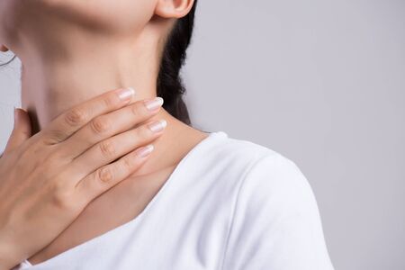 Sore Throat. Closeup Of Beautiful Young Woman Hand Touching Her Ill Neck. Healthcare and medical...