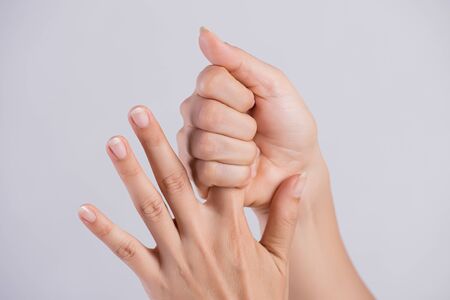 Healthcare and medical concept. Woman massaging her painful Index finger.