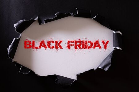 Top view of Black torn paper and the text black friday on a white background. Black Friday composition.の写真素材