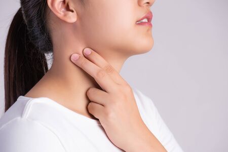 Sore Throat. Closeup Of Beautiful Young Woman Hand Touching Her Ill Neck. Healthcare and medical...