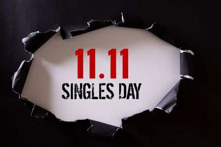 Online shopping of China, 11.11 singles day sale concept. Top view of Black torn paper and the text 11.11 singles day sale on a white background.の写真素材