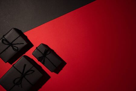 Top view of black gift box on black and red background with copy space for text. black Friday and Boxing Day composition.の写真素材