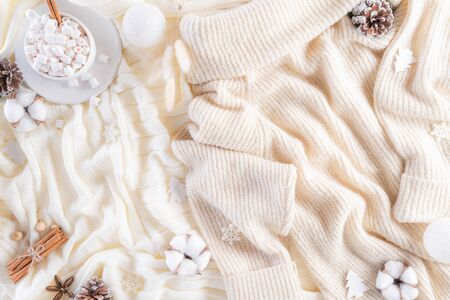 Winter composition. Gift box marshmallow cup, Christmas ball snowflakes, anise stars, beige sweater...