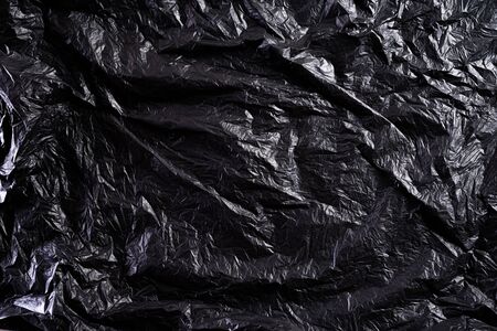 Top view of Black plastic bag texture and background. Reduction of plastic bags for natural treatment. Recycle and World Environment Day concept.の写真素材