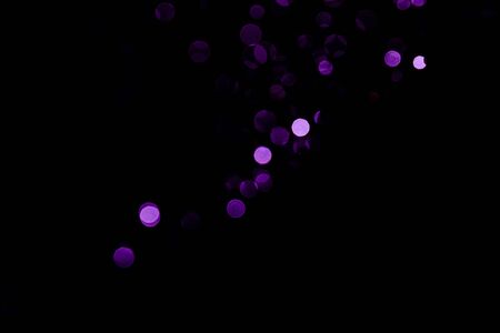 Abstract background purple bokeh with black background.の写真素材