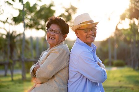 A happy senior couple asian old man and woman smiling and laughing in the garden, happy marriage....