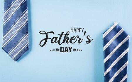 Happy Father's Day inscription with plaid tie on pastel blue background with text.