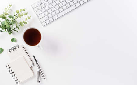 Flat lay, top view office table desk. Workspace with keyboard, office supplies, pencil and coffee...
