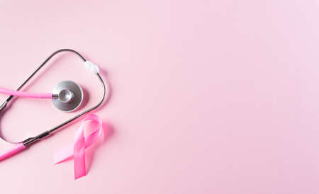 Pink ribbon and stethoscope on pastel pink background, Symbol of womens breast cancer awareness, Health care and medical concept.の写真素材