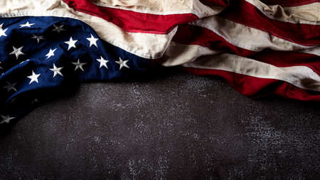 Happy Veterans Day concept. American flags against a dark stone  background. November 11.の写真素材