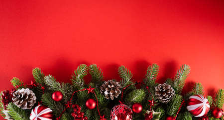 Christmas background concept. Top view of Christmas red balls with spruce branches, pine cones, red...