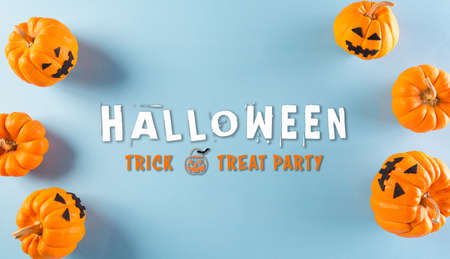 Top view of Halloween crafts made from orange ghost pumpkin on pastel blue background. Flat lay, top view with Halloween text.の写真素材