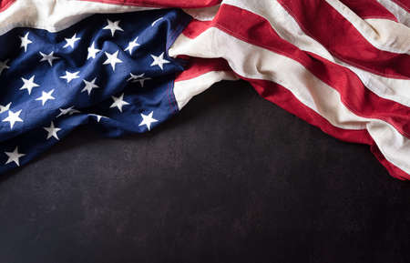 Happy Veterans Day concept. American flags against a dark stone  background. November 11.の写真素材