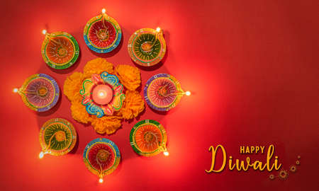 Happy Diwali - Clay Diya lamps lit during Dipavali, Hindu festival of lights celebration. Colorful...