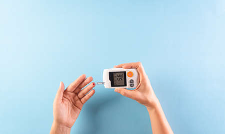 World diabetes day awareness concept. The diabetic measures the level of glucose in the blood, 14...
