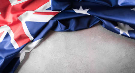 Happy Australia day concept. Australian flag against old stone background. 26 January.