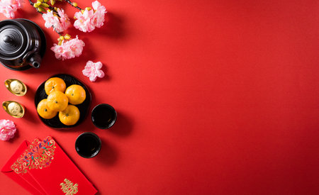 Chinese new year festival decorations pow or red packet, orange and gold ingots or golden lump on a red background. Chinese characters FU in the article refer to fortune good luck, wealth, money flow.の写真素材