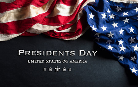 Happy presidents day concept with flag of the United States on black wooden background.