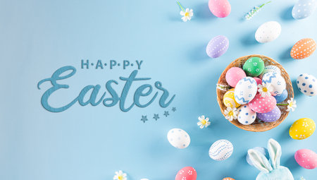 Happy easter! Colourful of Easter eggs in the nest with rabbit on pastel blue background. Greetings...