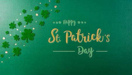 Happy St. Patricks Day decoration concept. Flat lay, top view of clover leaves on green background...
