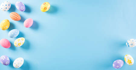 Happy easter! Colourful of Easter eggs on pastel blue background. Greetings and presents for Easter...