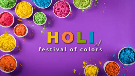 Happy holi festival decoration.Top view of colorful holi powder on purple  background with  text.の写真素材