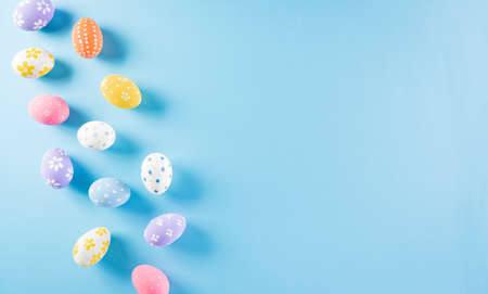 Happy easter! Colourful of Easter eggs on pastel blue background. Greetings and presents for Easter Day celebrate time. Flat lay ,top view.の写真素材