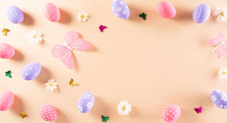 Happy easter! Colourful of Easter eggs in with flower on pastel background. Greetings and presents for Easter Day celebrate time. Flat lay ,top view.の写真素材