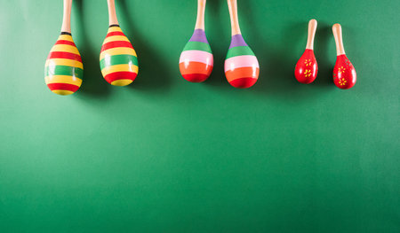 Cinco de Mayo holiday background made from maracas on green background.