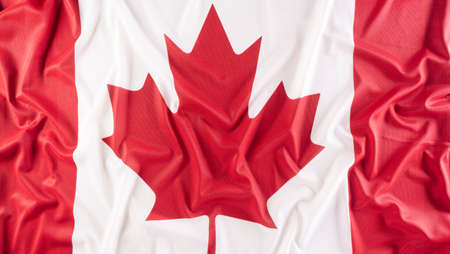A beautiful Canada national flag cloth fabric, a sign or symbol of Canada day concept.の写真素材
