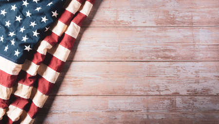 4th of July happy independence day concept. Vintage American flag on old wooden background.の写真素材