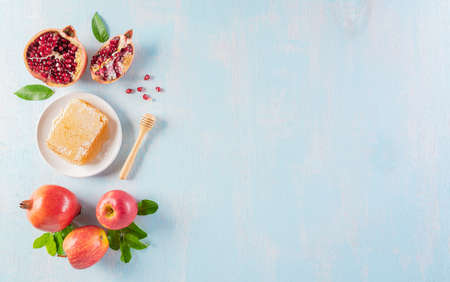 Rosh hashanah (jewish New Year holiday), Concept of traditional or religion symbols on blue pastel wooden background.の写真素材